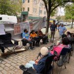 Community members camp outside of Senator Schumer's Brooklyn home.