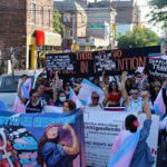 Community members hold banners and signs in Jackson Heights, Queens for our 11th Annual Translatinx March.